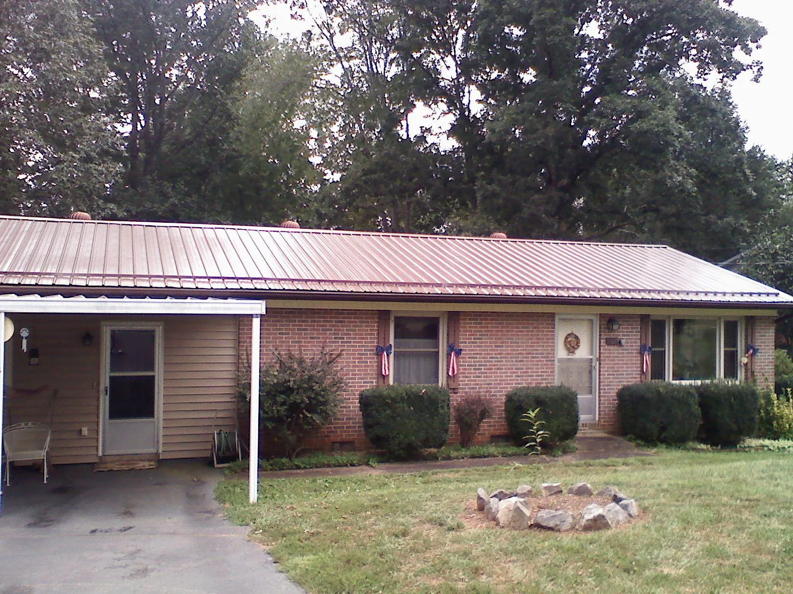 Bronze metal roof and carport on a brick ranch home — Roof Repair work by our crew in Shoreham